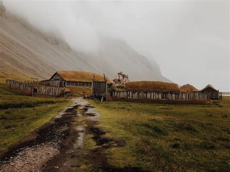Cottage Houses Below A Foggy Mountain · Free Stock Photo