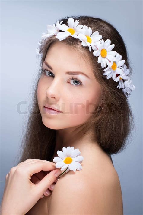 Сlose Portrait Of Beautiful Naked Girl With Light Makeup And Flowers