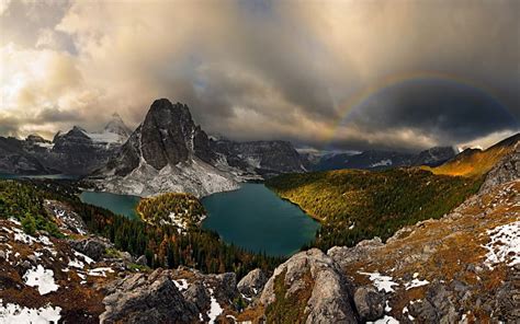 Cloudy Sky And Rainbow Over Mountain Landscape Lakes Trees Sky