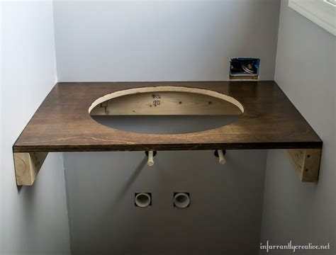 Transform a buffet into a cool floating bathroom vanity by installing double vessel sinks on it. DIY Floating Wood Vanity