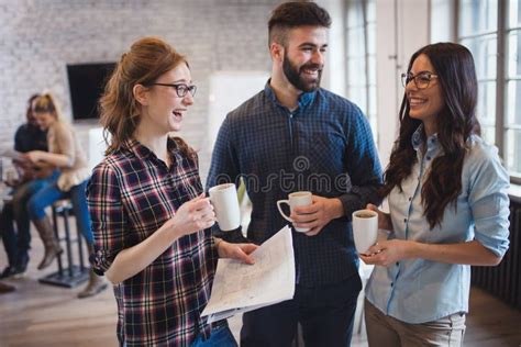 Coworking Colleagues Having Conversation At Workplace Stock Image