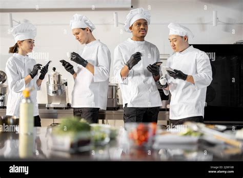 Team Of Multiracial Cooks Having Conversation During A Coffee Break In