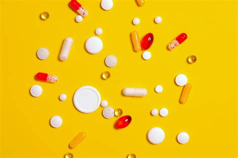 Medication Pills On Yellow Surface · Free Stock Photo