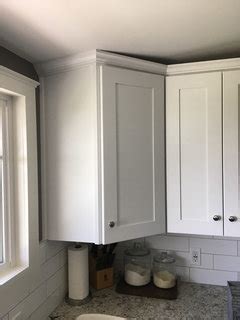 Cuts are made while crown molding is upside down. Crown molding on shaker style cabinets