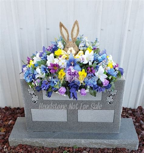 A Grave With Flowers And An Easter Bunny On It