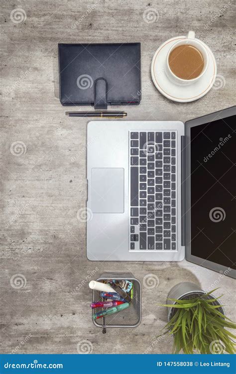Top View Of Business Desk With Laptop Coffee Potted Plant Notebook