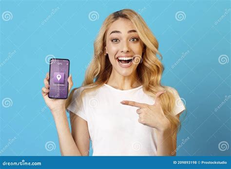 Cheerful Woman Showing Phone With Mobile Navigation Application Blue