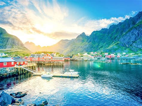 Beautiful Houses On Top Of Water With Sunbeam Mountains In Lofoten