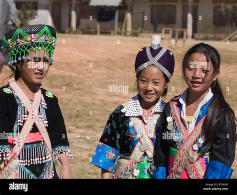 Three young Hmong girls in traditional costume at a Hmong New Year ...