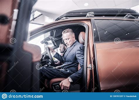 Businessman Pushing His Seat Back While Sitting In New Car Stock Image