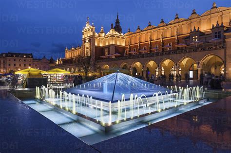 Poland Krakow Main Square In Old Town At Night Illuminated Fountain