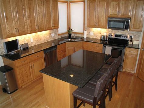 Uba tuba with oak and variegated tannish tiles with white and some slight streaks of black. Uba Tuba Granite Countertops (Pictures, Cost, Pros & Cons)