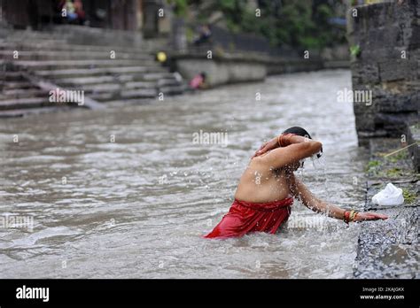 A Nepalese Hindu Woman Takes A Ritual Bath At The Bagmati River Of Pashupatinath Temple During
