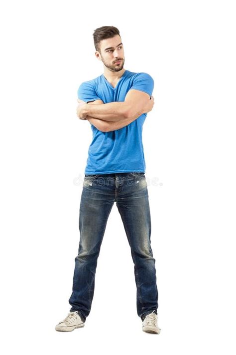 Young Man With Arms Wrapped Around Himself Looking Away Stock Image
