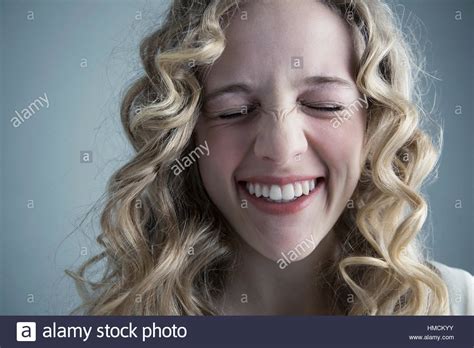 Close Up Portrait Caucasian Young Woman With Curly Blonde Hair Laughing