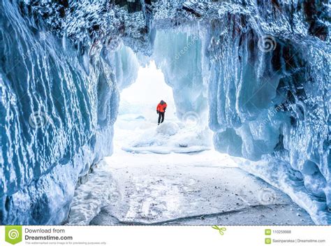 Winter Landscape Frozen Ice Cave With Young Photographer