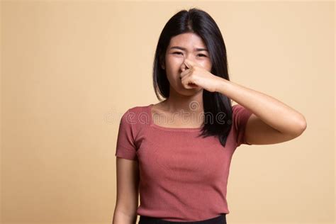 Young Asian Woman Holding Her Nose Because Of A Bad Smell Stock Image