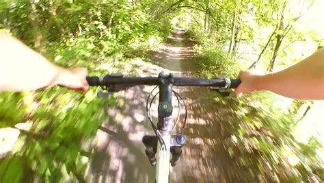 Extreme Girl Rides A Bicycle Along The River Bank Point Of View Pov