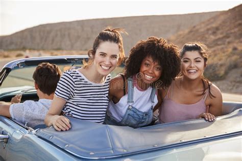 Portrait Of Three Female Friends Enjoying Road Trip In Open Top Classic Car Stock Image Image