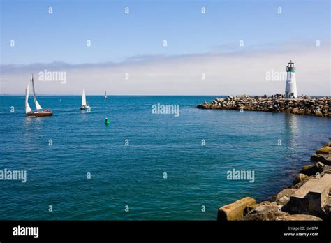 Lighthouse And Sail Boats Stock Photo Alamy