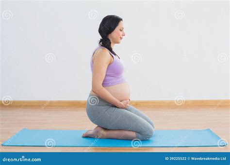 Pregnant Brunette Kneeling On Exercise Mat Stock Photo Image Of Belly Fitness
