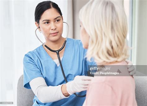 Shot Of A Female Doctor Examining A Patient With A Stethoscope High Res