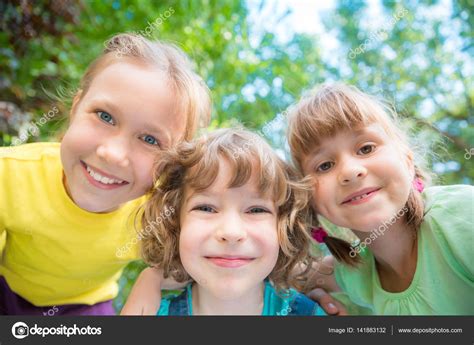 Happy Children Playing Outdoors Stock Photo By ©yaruta 141883132