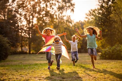 Group Of Happy Children Running In Public Park Review Of Myopia