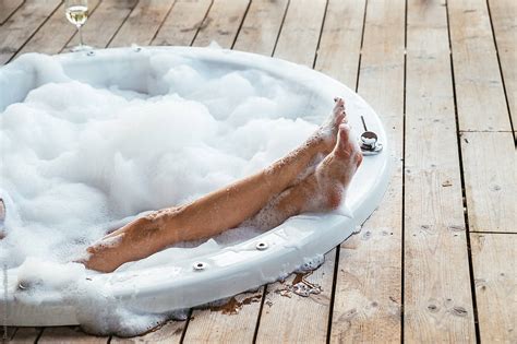 Crop Woman Relaxing In Hot Tub With Foam By Stocksy Contributor David Prado Stocksy