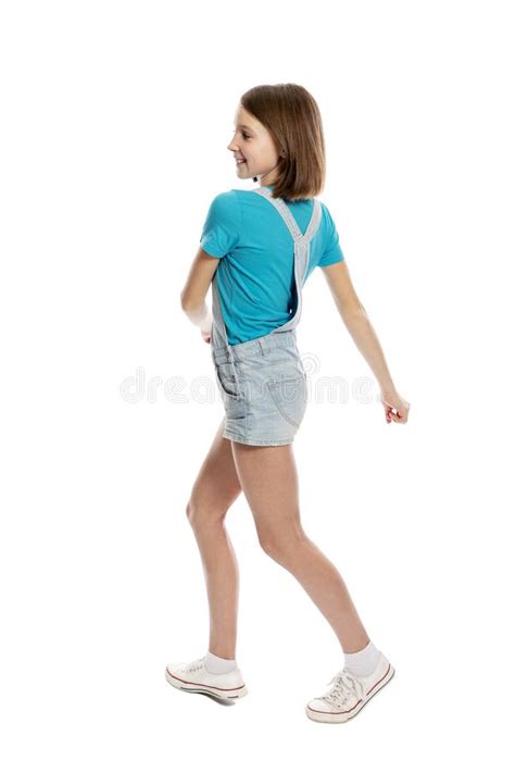 Teen Girl In Denim Overalls In A Flying Pose Full Height Isolated On A White Background Stock