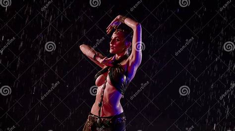 Busty Belly Dancer Woman Is Moving Slowly Under Rain At Night Medium