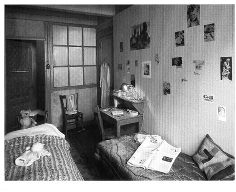 Two Beds In A Room With Pictures On The Wall