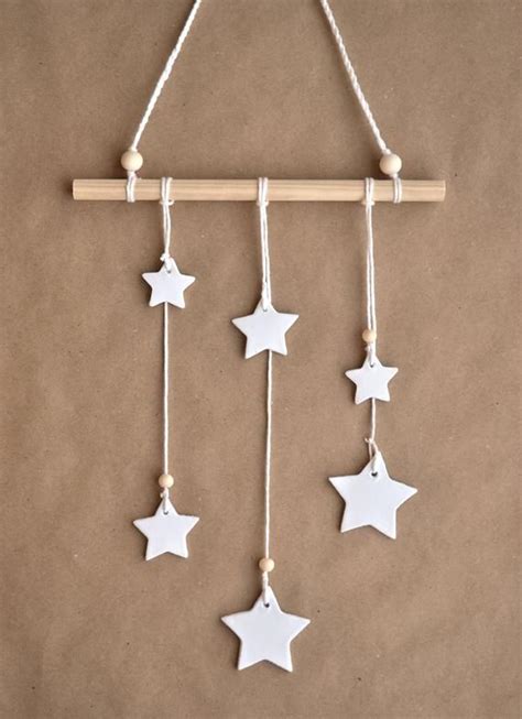 White Stars Hanging From A Wooden Stick On A Brown Background