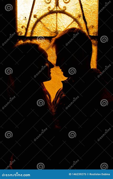 silhouette of a loving couple lovers embrace in the dark silhouette of a guy with a girl