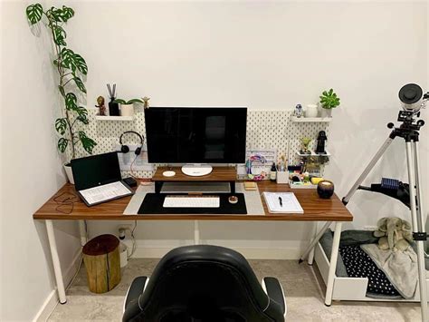 A Desk With A Computer Monitor Keyboard And Mouse On It In A Room