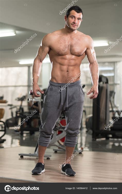 Hairy Muscular Man Flexing Muscles In Gym Stock Photo By ©ibrak 140564412
