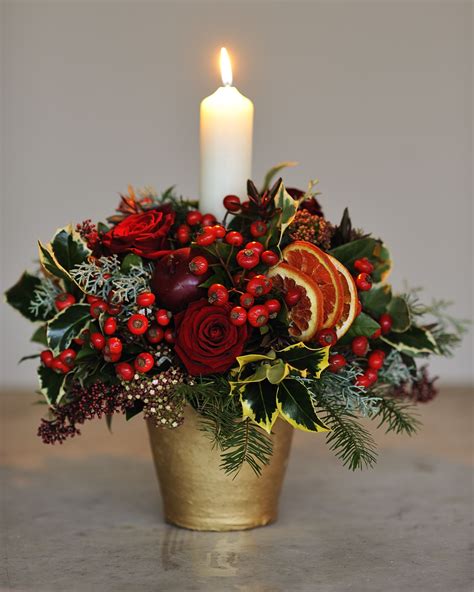 elegant christmas centerpiece with flowers and berries