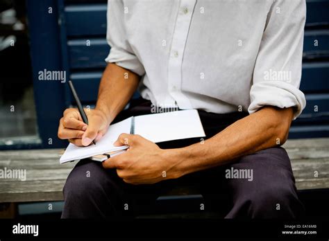 Man Writing In Notebook Stock Photo Alamy
