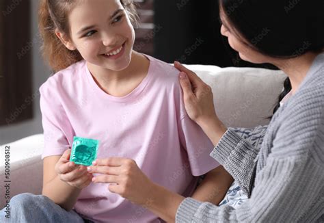 Mother Giving Condom To Her Teenage Daughter At Home Sex Education
