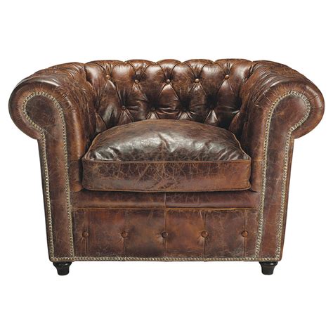 Featuring a chrome base, molded fiberglass frame, polyurethane foam padding, and light brown leather upholstery, this rounded chair is both comfortable and durable. Chesterfield leather button armchair in brown Vintage ...