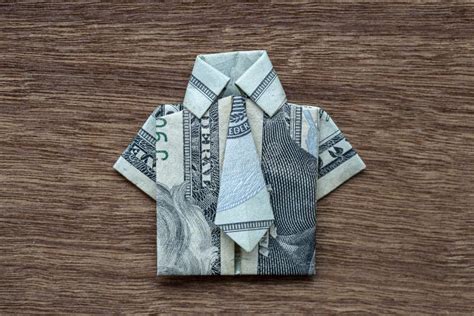 Origami Shirt Made Of Dollar Banknote On Wooden Background Closeup