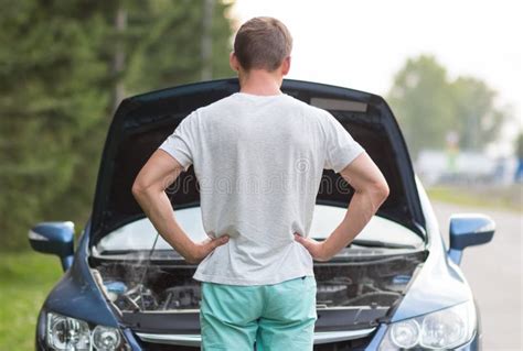 A Man Stands Near The Open Hood Of A Car The Car Needs Repair Stock