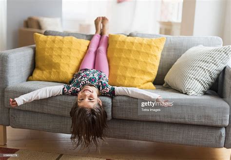 Usa New Jersey Girl Lying Upside Down On Sofa Photo Getty Images