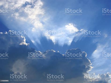 Blue Sky With Sun Rays Through The Clouds Stock Photo Download Image