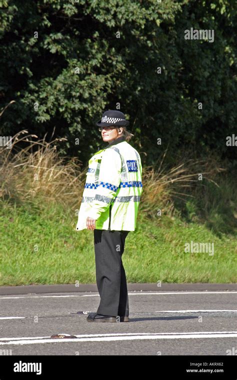 Police Officer Directing Traffic After A Road Traffic Accident Stock