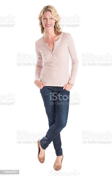 Beautiful Woman Standing Hands In Pockets Over White Background Stock