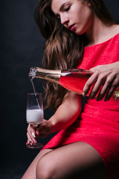 Woman Pouring Champagne In Glass Free Photo