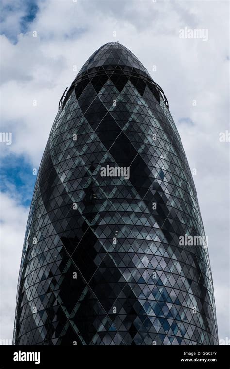 The Gherkin Against White Fluffy Clouds With A Splash Of Blue Skies