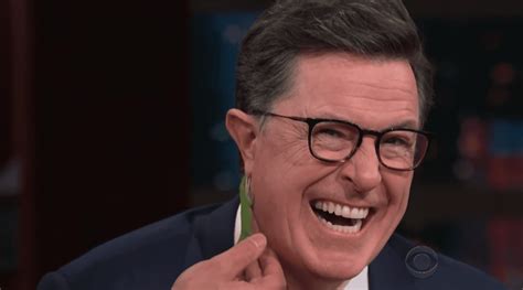 stephen colbert gets bit by a lizard on the ear