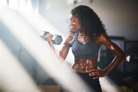 Fit African American Woman Lifting Iron In Home Gym Addicted To All